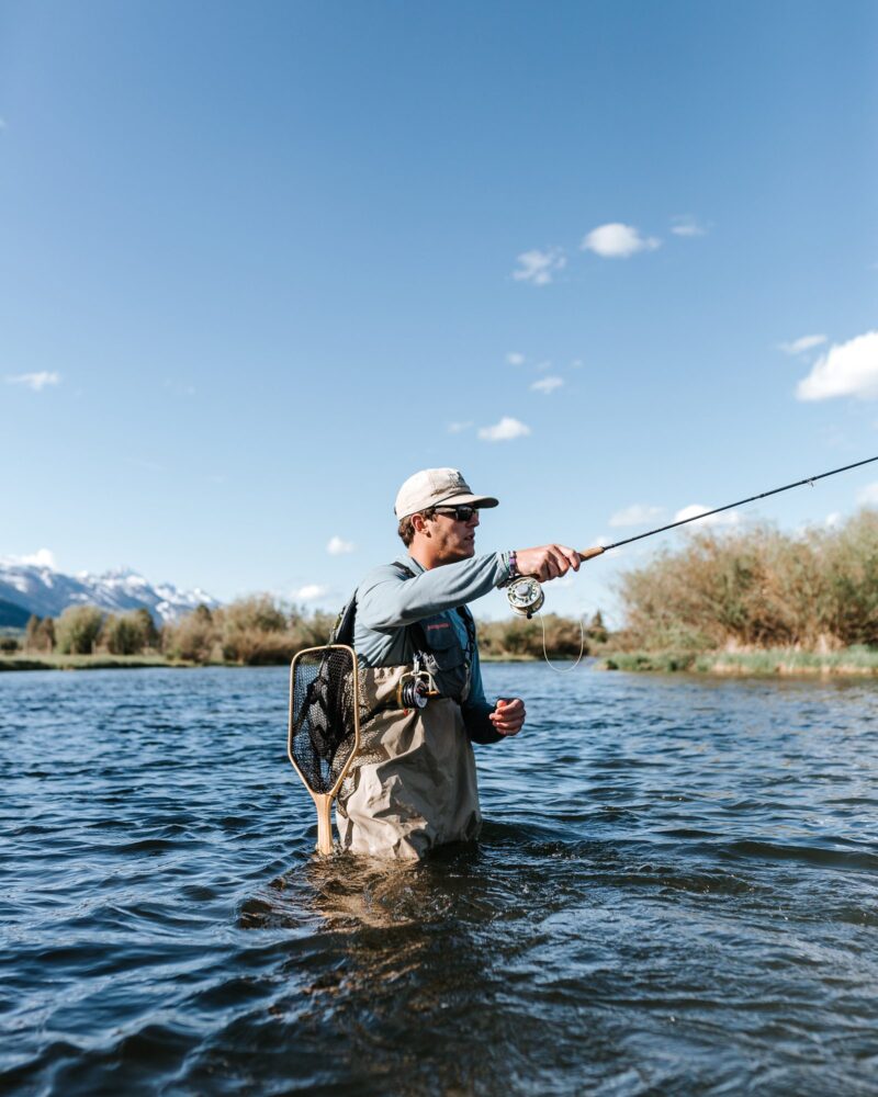 man fly fishing in river