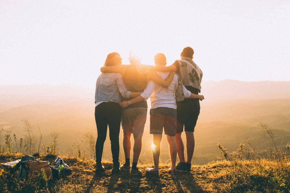 people in mountains hugging