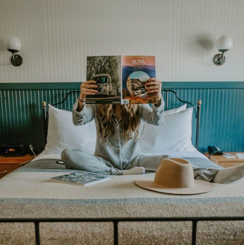 girl on bed in hotel room