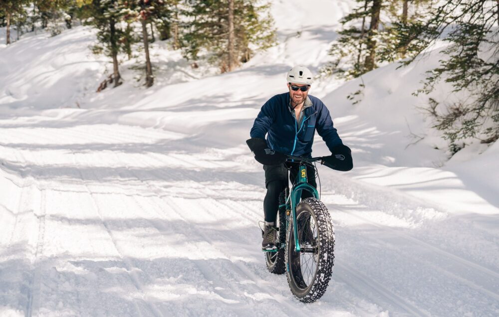 man on fat bike in snow mountain