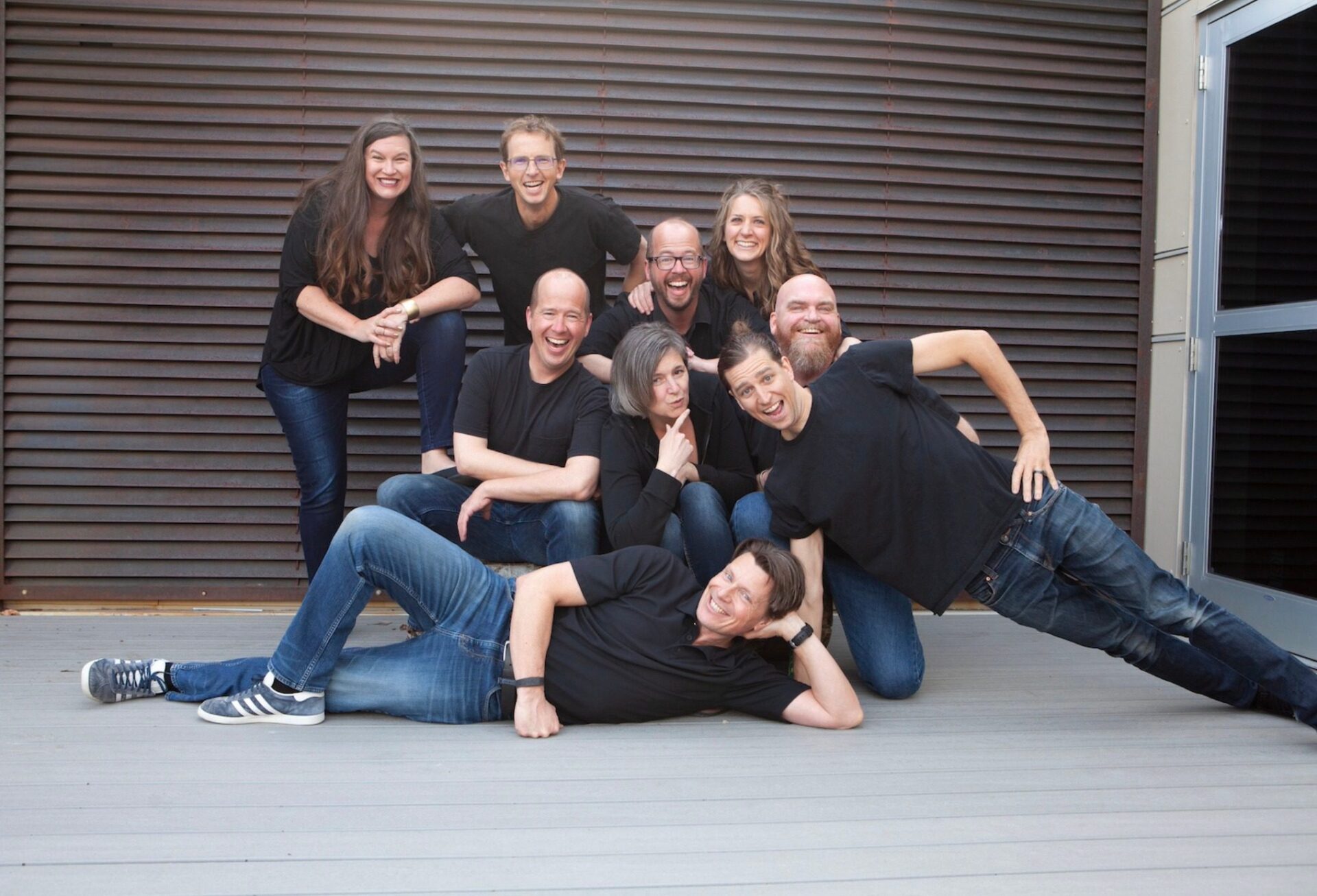 A photo of Laff Staff comedians posing in black tshirts and blue jeans.