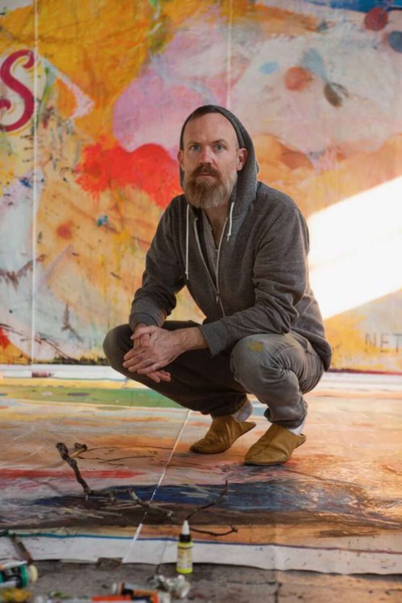 A photo of artist Tom Holmes in his studio.