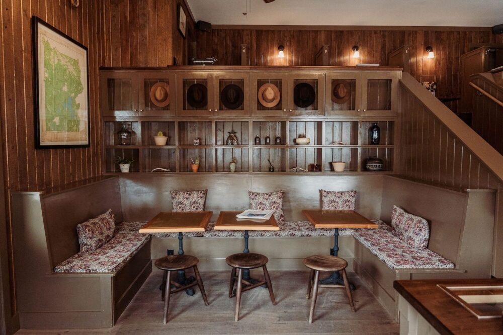 The lobby of Anvil Hotel Jackson, with a seating area and bookcases.