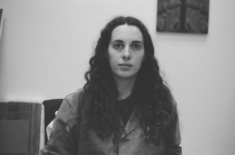 A black and white headshot of artist, Claire HarnEnz.