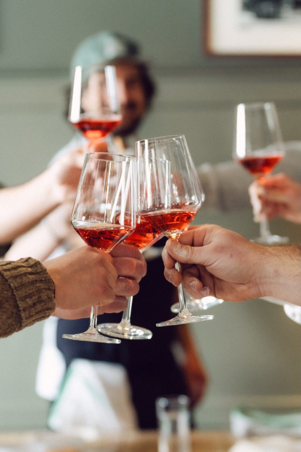 A group toasting wine glasses with rosé. Photo by Cat Campbell.