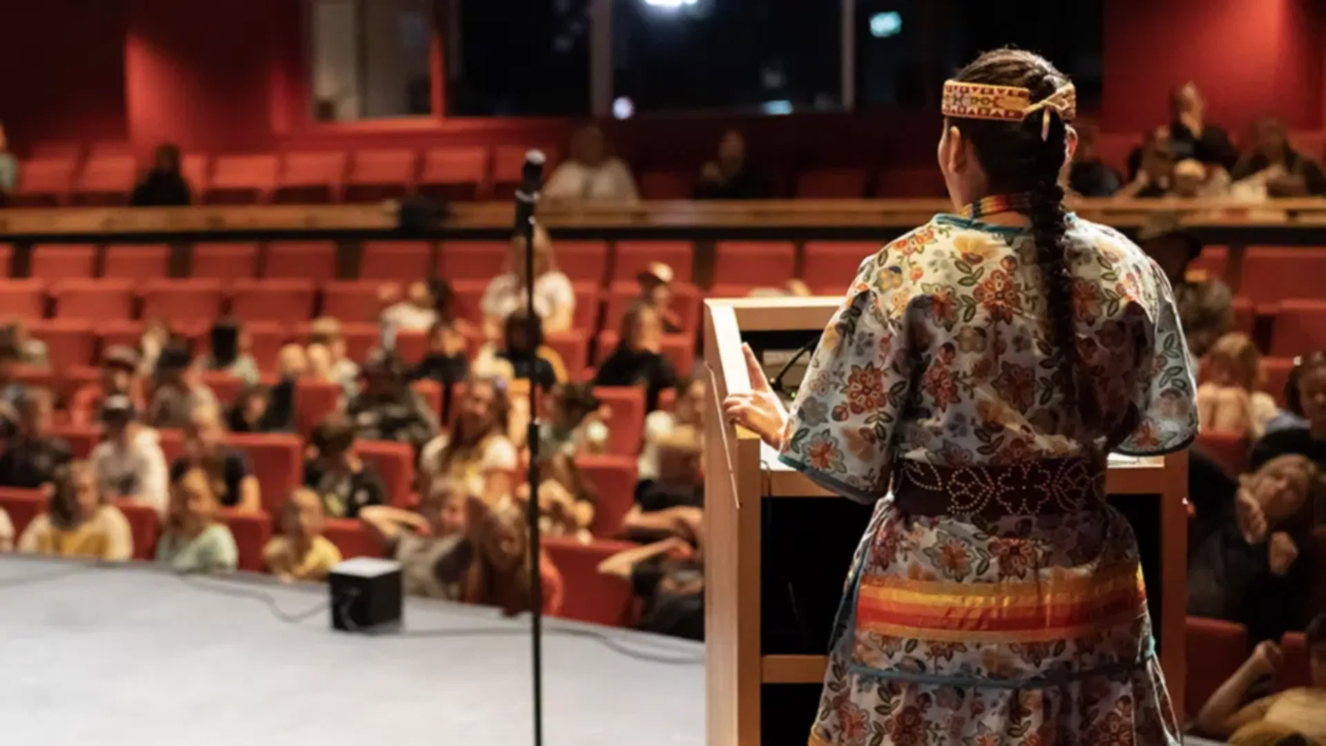 A woman speaking at a podium.