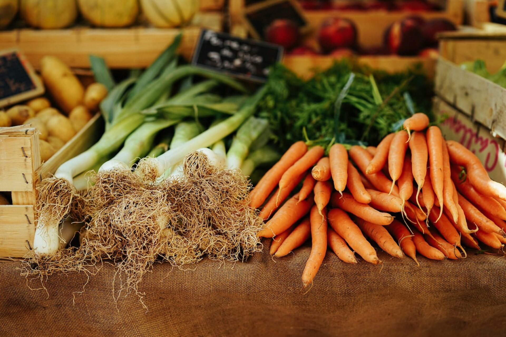 Carrots and green onions on a table at a local farmers market.