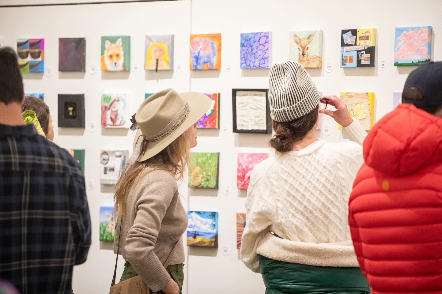 Two women looking at artwork in a gallery.