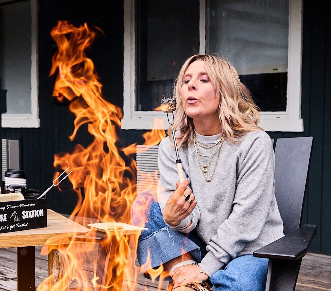 A woman having s'mores by the firepit at Anvil Hotel in Jackson.