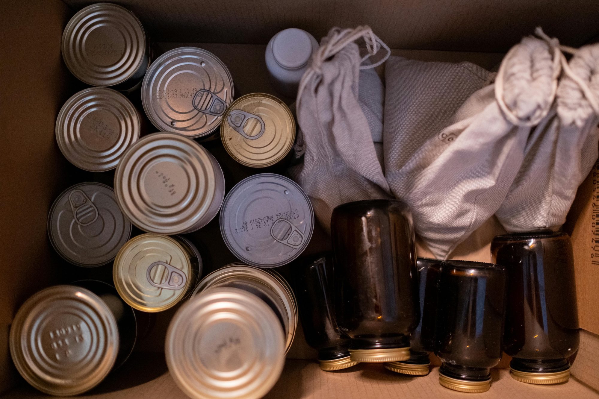 A box filled with canned goods.